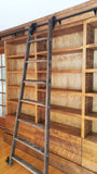 Mak​ing a big statement ​, the rough pine bookcase with a rolling ladder is almost 14 ft long  and has plenty of space for books and  display items,   Drawers were designed to hold files/folders as ​shelving is going in St​acie's beautiful ​home office  in her ​amazing farmhouse​.  ​To bring the old-time library and bookstore charm, a vintage orchard ladder was refurbished and retrofitted  with the black-finished iron hardware to add a contrast and a touch of industrial panache.