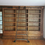 Mak​ing a big statement ​, the rough pine bookcase with a rolling ladder is almost 14 ft long  and has plenty of space for books and  display items,   Drawers were designed to hold files/folders as ​shelving is going in St​acie's beautiful ​home office  in her ​amazing farmhouse​.  ​To bring the old-time library and bookstore charm, a vintage orchard ladder was refurbished and retrofitted  with the black-finished iron hardware to add a contrast and a touch of industrial panache.