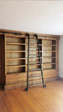 Mak​ing a big statement ​, the rough pine bookcase with a rolling ladder is almost 14 ft long  and has plenty of space for books and  display items,   Drawers were designed to hold files/folders as ​shelving is going in St​acie's beautiful ​home office  in her ​amazing farmhouse​.  ​To bring the old-time library and bookstore charm, a vintage orchard ladder was refurbished and retrofitted  with the black-finished iron hardware to add a contrast and a touch of industrial panache.