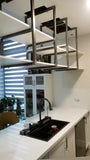 To maximize the storage with out blocking the view, shelves were mounted  on custom designed metal brackets which were suspended from ceiling , offering exceptional  seamless floating effect.