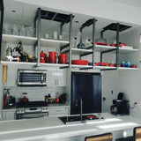To maximize the storage with out blocking the view, shelves were mounted  on custom designed metal brackets which were suspended from ceiling , offering exceptional  seamless floating effect.