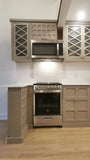 Custom kitchen with wood door & drawer fronts and stainless steel appliances.