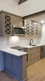 Custom kitchen with wood door & drawer fronts and stainless steel appliances.