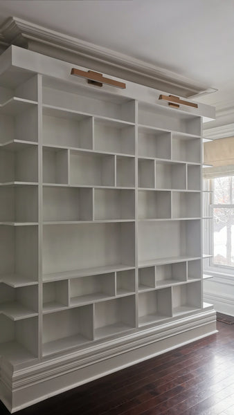 MCM-inspired design for a dream home library.

This custom bookcase stretches over 13 feet and features seven continuous shelves, offering ample display space for books, art, and collectibles.