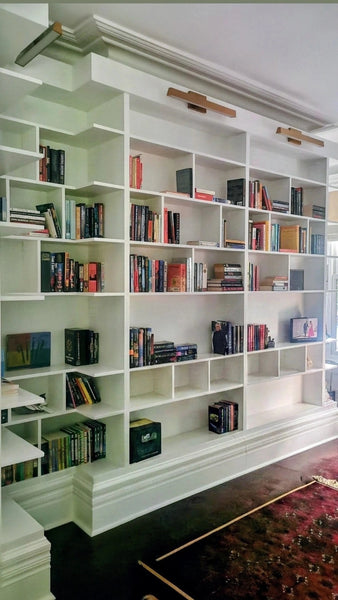 MCM-inspired design for a dream home library.

This custom bookcase stretches over 13 feet and features seven continuous shelves, offering ample display space for books, art, and collectibles.