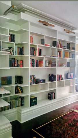 MCM-inspired design for a dream home library.

This custom bookcase stretches over 13 feet and features seven continuous shelves, offering ample display space for books, art, and collectibles.