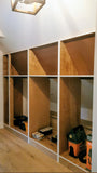A closet design   specifically tailored to fit rooms with sloped or slanted ceilings, featuring beveled shaker doors. The design maximizes storage while creating both a functional and beautiful space.