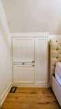 Custom-built angled cabinet designed for an unusual space under a sloped ceiling beside the bed, adding not only functional storage but also features a convenient pull-out nightstand.