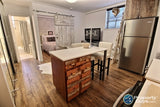 Custom built reclaimed teak wood with white patina  door & drawer panels  paired with  stainless steel appliance combines rustic warm wood with industrial chic.