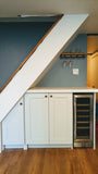 Every home can use more storage. Fortunately, the often-neglected space beneath a staircase provides an ideal spot for drawers and cabinets. This stylish example of under stair storage, offers space not only storage space but also a spot for a wine freezer and a counter top to display items or use it as a bar.