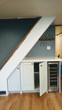 Every home can use more storage. Fortunately, the often-neglected space beneath a staircase provides an ideal spot for drawers and cabinets. This stylish example of under stair storage, offers space not only storage space but also a spot for a wine freezer and a counter top to display items or use it as a bar.