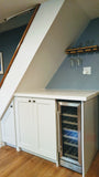 Every home can use more storage. Fortunately, the often-neglected space beneath a staircase provides an ideal spot for drawers and cabinets. This stylish example of under stair storage, offers space not only storage space but also a spot for a wine freezer and a counter top to display items or use it as a bar.