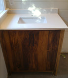 This gorgeous modern clean line bathroom vanity built from solid poplar wood with a white quartz  top and a ceramic sink adds a perfect rustic & warn touch to this bathroom.