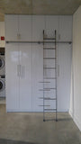 Modern white closet boasts custom built metal ladder and a 7ft long metal rail .  Ladder with multiple hooks was specially designed so it can be used not only for the tall  closet in the bedroom but also in the kitchen. Allowing  for maximum versatility on multiple rails and to store it elsewhere.