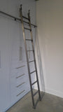 Modern white closet boasts custom built metal ladder and a 7ft long metal rail .  Ladder with multiple hooks was specially designed so it can be used not only for the tall  closet in the bedroom but also in the kitchen. Allowing  for maximum versatility on multiple rails and to store it elsewhere.