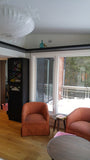 Every home can use more storage.  A half wall that separates the entry to this sun filled room is used to display a gorgeous bookshelf with distinct glass door sporting a hand carved  criss-cross design plus a decorative film.  The floating shelves fits in perfectly with any home that prefer shelf spaces with clean and well defined lines.  The idea also saves up on space and gives you a stylish display area that you can use in various forms!