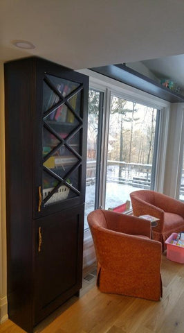 Every home can use more storage.  A half wall that separates the entry to this sun filled room is used to display a gorgeous bookshelf with distinct glass door sporting a hand carved  criss-cross design plus a decorative film.  The floating shelves fits in perfectly with any home that prefer shelf spaces with clean and well defined lines.  The idea also saves up on space and gives you a stylish display area that you can use in various forms!