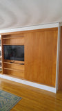 A librarian's (our client) dream home library and TV Unit.  Incredible MCM inspired library/ bookcase and built in TV unit featuring a stunning sliding door.  The bookcase  which stretches over 30ft ​ boast ​seven shelves ​running all the way through ​offering plenty of ​ ​display space for books, art, ​etc​  TV unit is hidden with a beautiful 54" wide sliding door oozing out Danish charm and practicality.