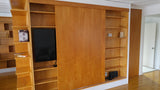 A librarian's (our client) dream home library and TV Unit.  Incredible MCM inspired library/ bookcase and built in TV unit featuring a stunning sliding door.  The bookcase  which stretches over 30ft ​ boast ​seven shelves ​running all the way through ​offering plenty of ​ ​display space for books, art, ​etc​  TV unit is hidden with a beautiful 54" wide sliding door oozing out Danish charm and practicality.