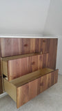 An absolutely spectacular 13 ft long MCM inspired dresser / bedroom unit. Custom build unit boast 9 soft close drawers with under mount slides and 2 door panels on either ends. Which can easily handle all storage needs with ease and still look splendid! Fronts built from beautiful walnut with exceptional grain pattern throughout. The vintage pulls and shell shape handles add a time less feel. A sleek and streamlined white exterior with recessed kick giving it the floating look