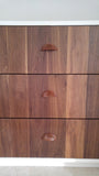 An absolutely spectacular 13 ft long MCM inspired dresser / bedroom unit. Custom build unit boast 9 soft close drawers with under mount slides and 2 door panels on either ends. Which can easily handle all storage needs with ease and still look splendid! Fronts built from beautiful walnut with exceptional grain pattern throughout. The vintage pulls and shell shape handles add a time less feel. A sleek and streamlined white exterior with recessed kick giving it the floating look