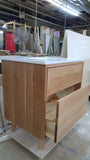 This 30" gorgeous MCM  inspired vanity features solid wood frame, legs and drawer fronts built from white oak.   Modern lines and beautiful  & warm wood grains makes it a perfect statement in any contemporary bathroom.  Two functional  drawers with soft-close slides offer plenty of storage.  The counter top is a low maintenance and durable single edge white quartz  with an under-mount ceramic sink