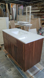   This 48" gorgeous MCM  inspired vanity features solid wood frame, legs and door & drawer fronts built from  walnut with exceptional grain pattern throughout.  Modern lines and beautiful  & warm wood grains makes it a perfect statement in any contemporary bathroom.  Two precisely inset doors and six functional drawers with soft-close slides offer plenty of storage for a growing family.  The counter top is a low maintenance and durable single edge white quartz  with an under-mount ceramic sink.