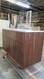   This 48" gorgeous MCM  inspired vanity features solid wood frame, legs and door & drawer fronts built from  walnut with exceptional grain pattern throughout.  Modern lines and beautiful  & warm wood grains makes it a perfect statement in any contemporary bathroom.  Two precisely inset doors and six functional drawers with soft-close slides offer plenty of storage for a growing family.  The counter top is a low maintenance and durable single edge white quartz  with an under-mount ceramic sink.