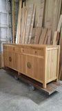 A modern makeover to an age-old distinct Chinese simple clean line design.  This remarkable sideboard is built from  stunning  warm & gorgeous solid white oak wood and boasts beautiful classic Chinese round brass cabinet face-plate door & drawer pulls.  It provides a large amount of storage space to hold a great deal, from dishes and table linen to board games.  67" W x 30" H  x 18" D