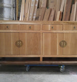 A modern makeover to an age-old distinct Chinese simple clean line design.  This remarkable sideboard is built from  stunning  warm & gorgeous solid white oak wood and boasts beautiful classic Chinese round brass cabinet face-plate door & drawer pulls.  It provides a large amount of storage space to hold a great deal, from dishes and table linen to board games.  67" W x 30" H  x 18" D