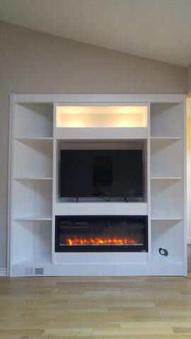 Living room built-ins can add style and personality as well as storage.  An asymmetrical alcove  can be incredibly difficult to furnish – especially when you have to negotiate with walls at different angles.  The bland space  was transformed into spectacular builtin with a TV unit & an electric fireplace plus additional storage!