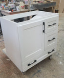 Shown in the photos is a 30" wide custom floating vanity designed to accommodate a off centered sink.  Cabinet built  from solid poplar wood.  Shaker style fronts.  Soft close drawers and doors.  Painted white.   30" W x  18" D x  32" (ht)  Send us your rough sketch with dimensions along with your inspiration photos of your dream bathroom vanity,