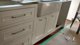 custom build white recessed paneled solid wood cabinetry with timeless white framhouse sink.