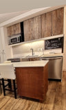 Old chocolate brown doors were replaced with custom built reclaimed teak wood fronts with white patina to match the sliding old barn door across from the kitchen.  By switching white appliance to stainless steel  and moving the fridge to the corner to make space for the dishwasher kitchen was made more functional & spacious.  The island design incorporates a colorful cabinet with metal frame giving a warm & industrial look.