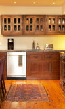 We used vintage shallow and narrow medicine cabinets on either side of the hood.  Three floor reclaimed teak cabinets were joined together and turned into a stunning wall unit.  The cabinet's old patina and wood grains combined with modern stainless steel appliances brings warmth, elegance and beautiful ambiance to the kitchen.  This is a perfect example of a super warm, cozy and charming Inde-Art kitchen.