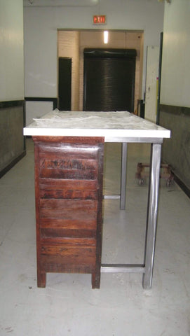 A one of a kind cabinet built from reclaimed teak wood was turned into an island by attaching a custom made metal frame onto it's back. The Italian marble as counter top adds a sleek and modern character. The island has old world nostalgia but anchored in the present with timeless simplicity. A perfect combination for creating elegance with a touch of rustic and modern - a beautiful centerpiece for any kitchen