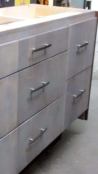We designed this stunning island for to maximize storage need for a growing family. - Drawer fronts built from reclaimed teak wood - Paneled back & sides - A playful balance of casual and sophisticated.
