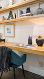 Don’t think you have the space for a home office? Think again  In this condo, hallway becomes a home office. To make the most of the space, a floating desk and shelving above it makes room for books,etc  Made from solid poplar wood.