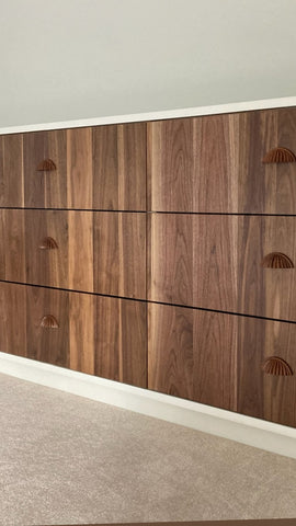 An absolutely spectacular 13 ft long MCM inspired dresser / bedroom unit. Custom build unit boast 9 soft close drawers with under mount slides and 2 door panels on either ends. Which can easily handle all storage needs with ease and still look splendid! Fronts built from beautiful walnut with exceptional grain pattern throughout. The vintage pulls and shell shape handles add a time less feel. A sleek and streamlined white exterior with recessed kick giving it the floating look
