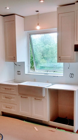 Beautiful & elegant custom build white recessed solid wood paneled cabinetry with a timeless farmhouse sink, a custom hood and dishwasher cover serves as a clean slate for beautiful walnut wood island, a playful balance of traditional and modern. Solid walnut wood with 2.5" frame, 6 flat panel drawers and a microwave shelf. A perfect example of contrasting textures mixed to keep it family friendly, and at the same time a strong statement piece.