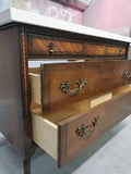 The vintage dresser was modified to accommodate the plumbing  including  new under-mount soft close  drawer boxes with cut outs and white quartz top with an under-mount sink.  Allowing the luxurious vintage look & feel but also the modern convenience & functionality.