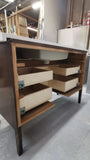 The vintage dresser was modified to accommodate the plumbing  including  new under-mount soft close  drawer boxes with cut outs and white quartz top with an under-mount sink.  Allowing the luxurious vintage look & feel but also the modern convenience & functionality.