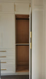 U shaped custom closet, designed to fit this unique space in a third floor bedroom of downtown house, featuring inset shaker style fronts with bead design and a gorgeous black closet island with additional drawers & pull out for a laundry hamper.  The closets provide ample hanging, drawer, and shelf space for clothing , etc. 