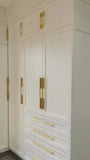 U shaped custom closet, designed to fit this unique space in a third floor bedroom of downtown house, featuring inset shaker style fronts with bead design and a gorgeous black closet island with additional drawers & pull out for a laundry hamper.  The closets provide ample hanging, drawer, and shelf space for clothing , etc. 