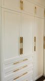 U shaped custom closet, designed to fit this unique space in a third floor bedroom of downtown house, featuring inset shaker style fronts with bead design and a gorgeous black closet island with additional drawers & pull out for a laundry hamper.  The closets provide ample hanging, drawer, and shelf space for clothing , etc. 