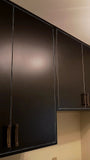 There’s no reason your laundry room shouldn’t be as beautiful as the rest of your home.  An outdated laundry room  was transformed into a bold  & sophisticated space with Asian inspired black custom cabinets & brass pulls.  A gorgeous sink cabinet with  black veined quartz counter top and extra deep stainless steel sink.  Wall cabinets provide plenty of shelf space and  hanging rod.