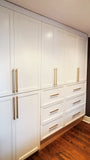 A custom closet, designed to fit this unique & unusual space for a 2nd floor bedroom of a downtown house, Featuring shaker style fronts with bead design and cabinet boxes & drawers boxes build from a gorgeous maple wood plywood. The closets provide ample hanging, drawer, and shelf space for clothing, etc.