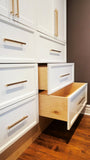 A custom closet, designed to fit this unique & unusual space for a 2nd floor bedroom of a downtown house, Featuring shaker style fronts with bead design and cabinet boxes & drawers boxes build from a gorgeous maple wood plywood. The closets provide ample hanging, drawer, and shelf space for clothing, etc.
