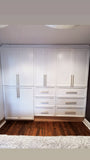 A custom closet, designed to fit this unique & unusual space for a 2nd floor bedroom of a downtown house, Featuring shaker style fronts with bead design and cabinet boxes & drawers boxes build from a gorgeous maple wood plywood. The closets provide ample hanging, drawer, and shelf space for clothing, etc.