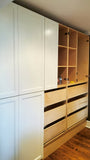 A custom closet, designed to fit this unique & unusual space for a 2nd floor bedroom of a downtown house, Featuring shaker style fronts with bead design and cabinet boxes & drawers boxes build from a gorgeous maple wood plywood. The closets provide ample hanging, drawer, and shelf space for clothing, etc.